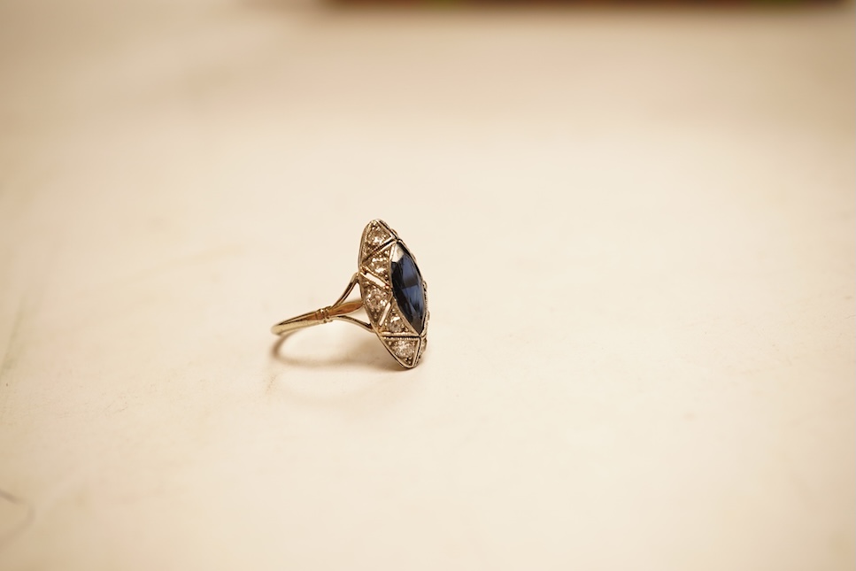 A 1920's style white metal, sapphire and diamond cluster set navette shaped ring, size G, gross weight 2.4 grams.